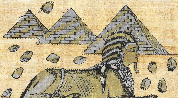 Un antico papiro egiziano che mostra una sfinge e piramidi