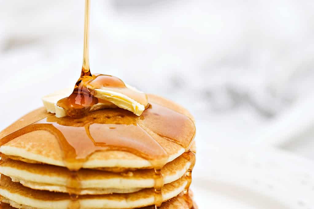 Sciroppo d'acero versato sui pancake.
