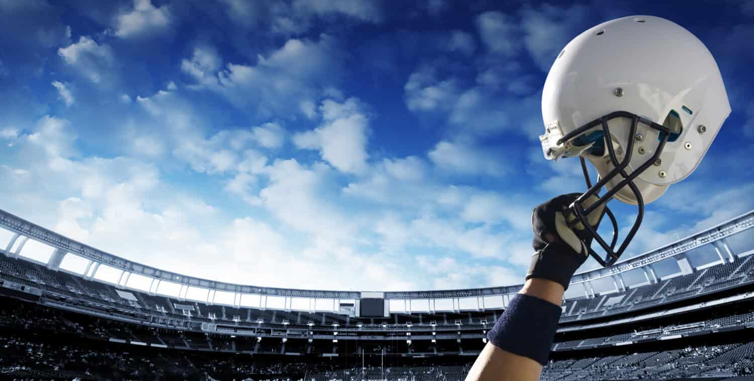 Il giocatore di football alza il casco prima di una partita importante