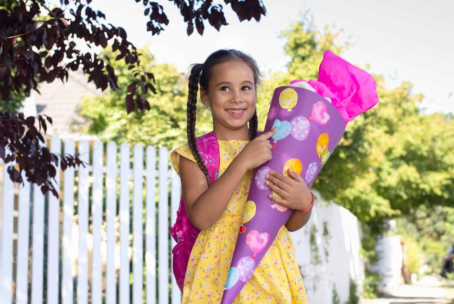 La bambina sta tenendo uno schultute il primo giorno di scuola