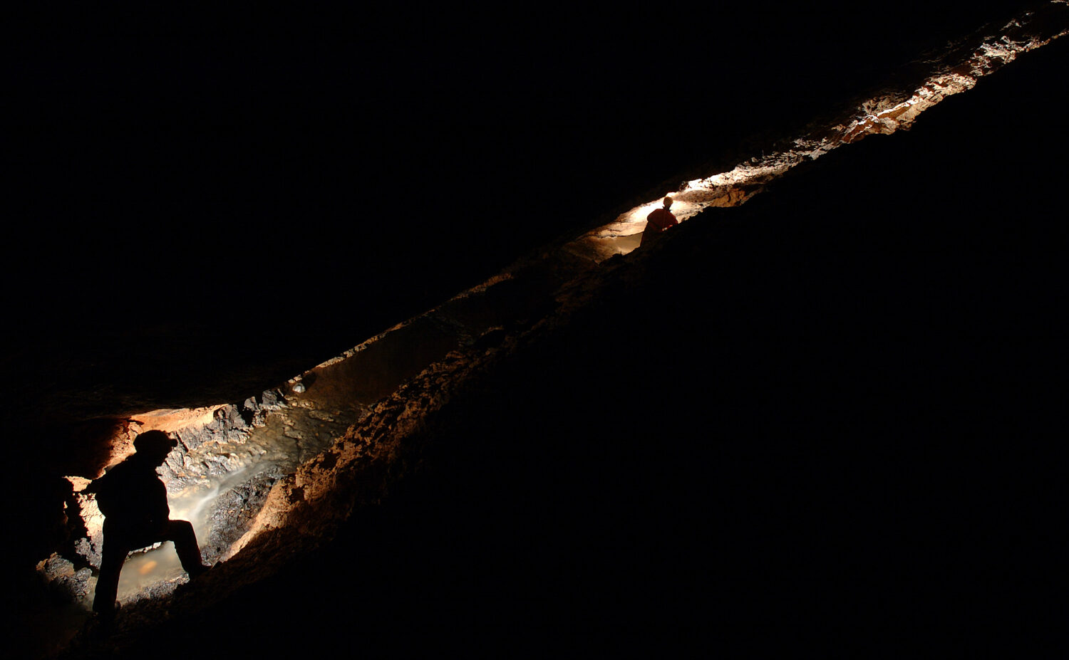 Speleologi che esplorano un fiume sotterraneo