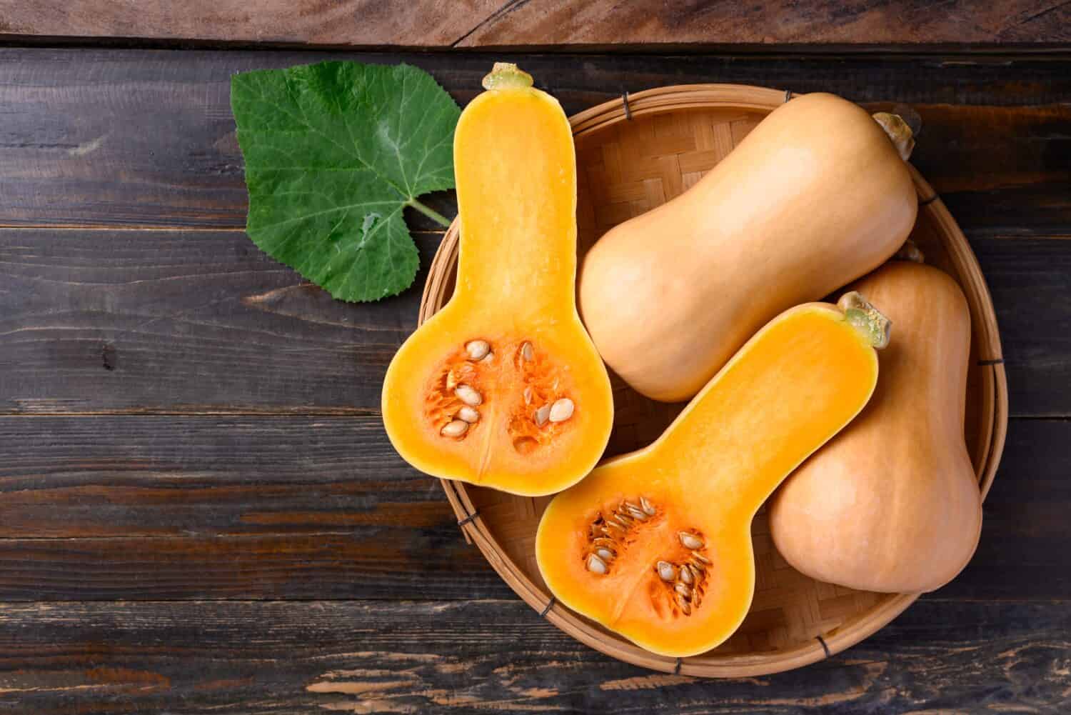 Merce nel carrello della zucca o della zucca butternut su fondo di legno, vista del piano d'appoggio