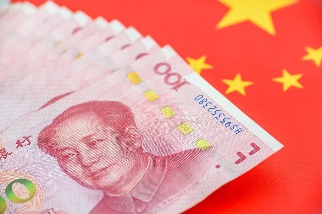 Denaro/valuta della PBOC o della Banca popolare cinese.  Banconota da cento yuan cinesi con la bandiera della Cina.  100 rmb o renminbi, raffigura il sistema economico di Pechino, la politica bancaria pubblica e il tasso di interesse