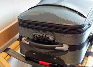 A suitcase in a hotel room. Bed Bugs can hitch rides in your suitcase while traveling. Find out how to protect against bed bugs on your next trip.